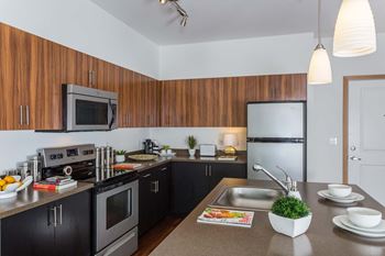 Fully Furnished Kitchen With Stainless Steel Appliances at Tivalli Apartments, Lynnwood, WA